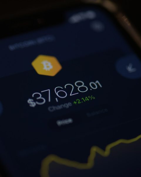 a close up of a cell phone with a bitcoin on it