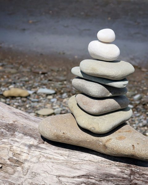 a stack of rocks on a wood surface