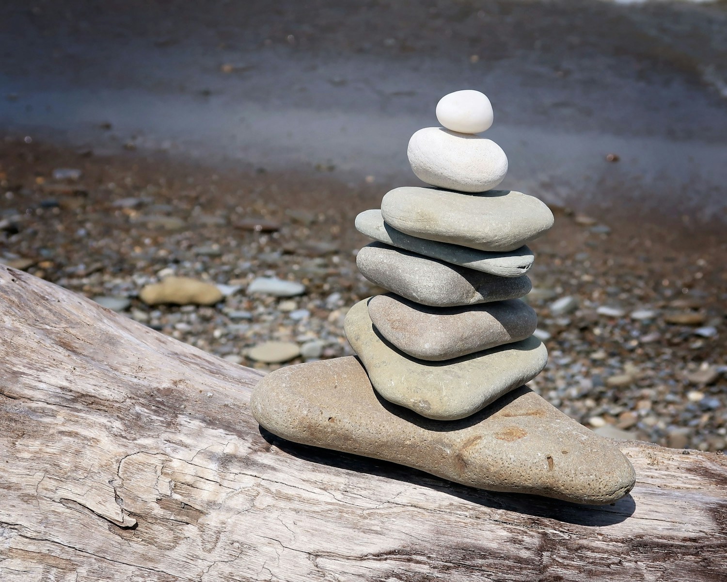 a stack of rocks on a wood surface