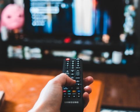 person holding black remote control