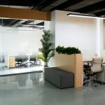 an office with a plant in the middle of the room