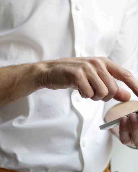 person holding white Android smartphone in white shirt