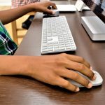 Een student die op een laptop spelletjes speelt in een schoolomgeving