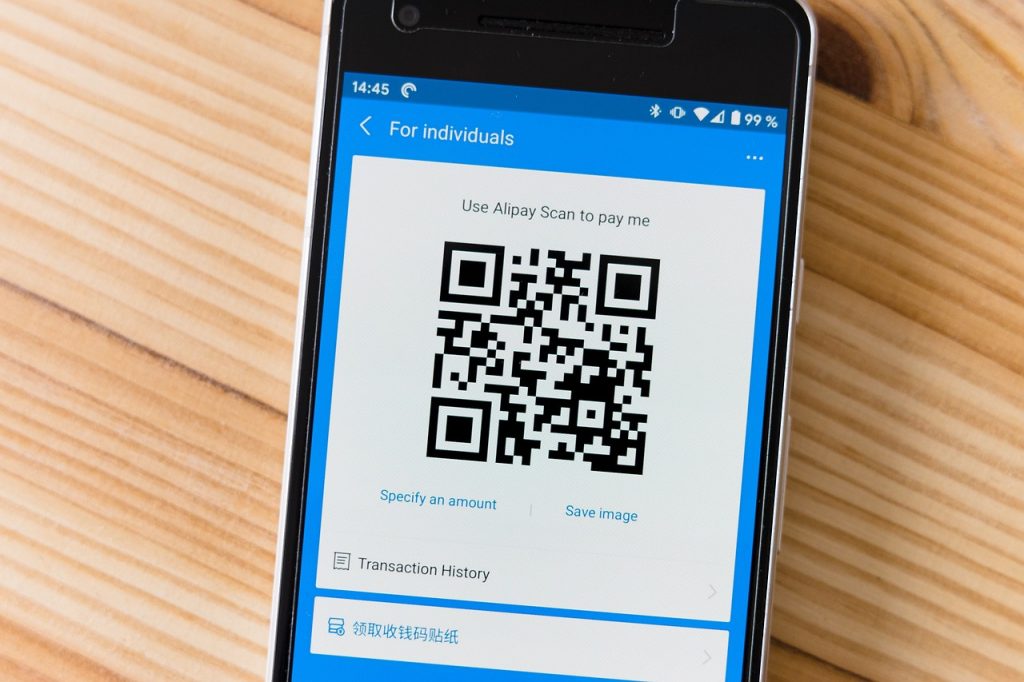 Ondernemer scant een barcode in een magazijn met zijn smartphone