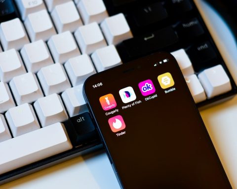 a cell phone sitting next to a keyboard