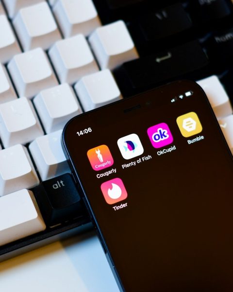 a cell phone sitting next to a keyboard